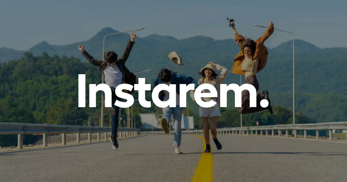 Four friends jump mid-air on a sunny road with mountains in the background, bold 'Instarem' branding across the center.